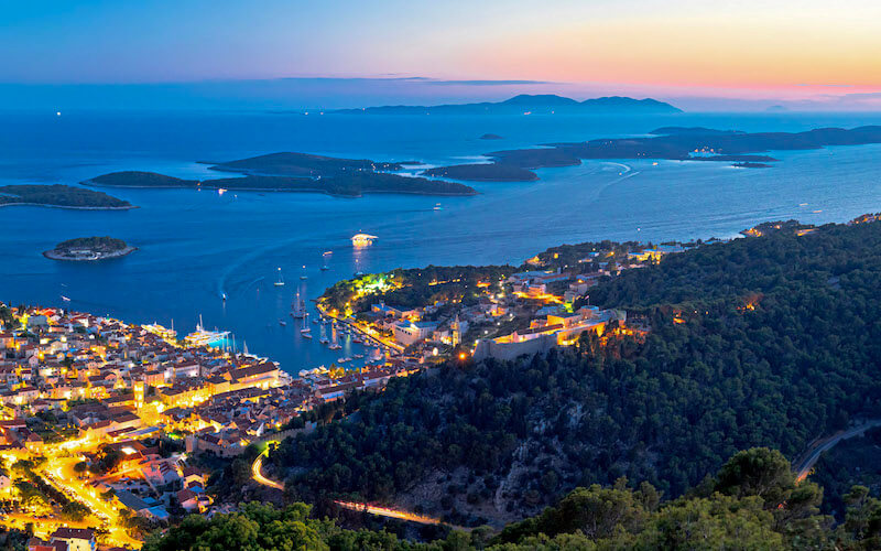 Sunset over Hvar and its fort, with Palmizana and Vis in the distance